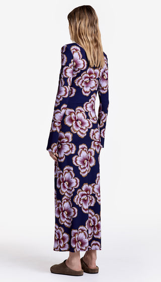 Woman wearing a long floral dress on a white background
