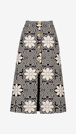 Skirt with black and white geometric pattern and floral embellishments on a white background