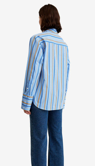 Person wearing a blue and white striped shirt with a white background