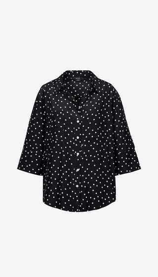 Black shirt with white polka dot pattern on a white background