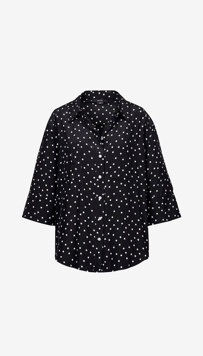 Black shirt with white polka dot pattern on a white background