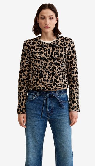 Woman wearing a leopard print sweater and blue jeans on a white background