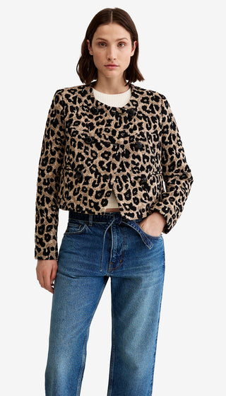 Woman wearing a leopard print sweater and blue jeans on a white background
