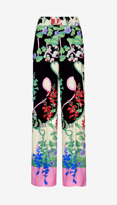 Colorful floral and bird patterned pants on a white background