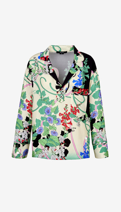 Colorful floral and abstract patterned blouse on a white background