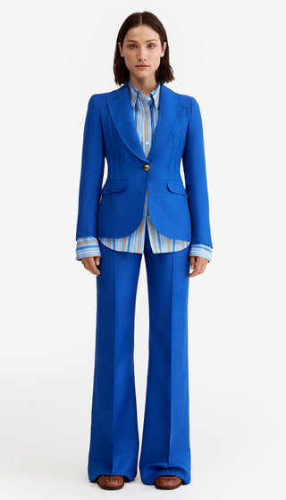 Woman wearing a blue suit with a white background