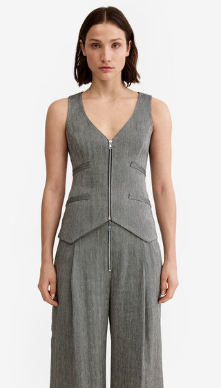 Woman wearing a gray sleeveless jumpsuit on a white background