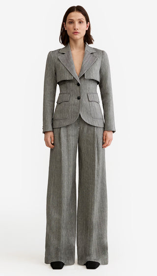 Woman wearing a gray suit on a white background