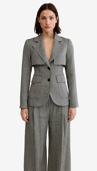 Woman wearing a gray suit on a white background