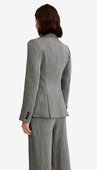 Person wearing a gray suit on a white background