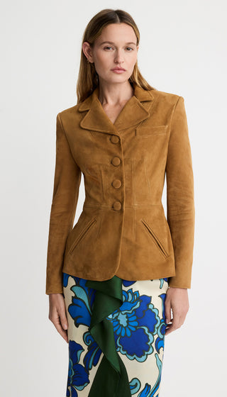 Woman wearing a brown suede jacket on a white background