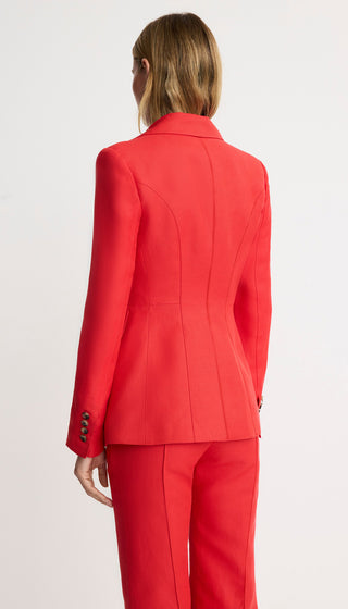 Red suit worn by a person on a white background