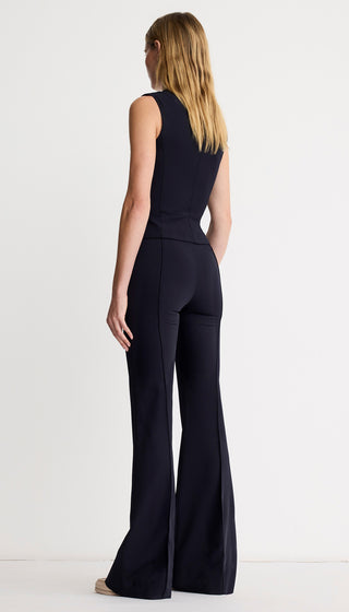 Black jumpsuit worn by a person on a white background