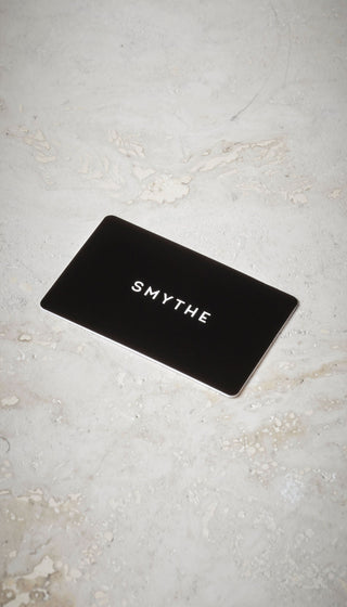 A SMYTHE gift card on a table.